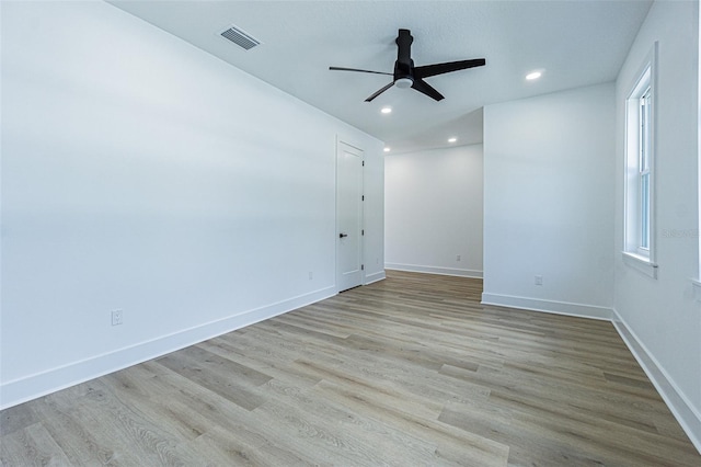 unfurnished room featuring recessed lighting, wood finished floors, a ceiling fan, and baseboards