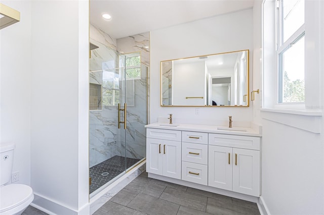 full bath with plenty of natural light, a sink, and a marble finish shower