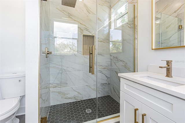 full bathroom with toilet, a marble finish shower, and vanity