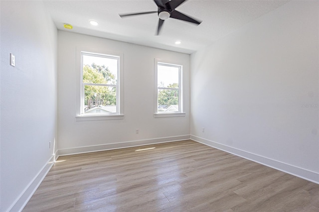 unfurnished room with light wood-style floors, recessed lighting, baseboards, and a ceiling fan