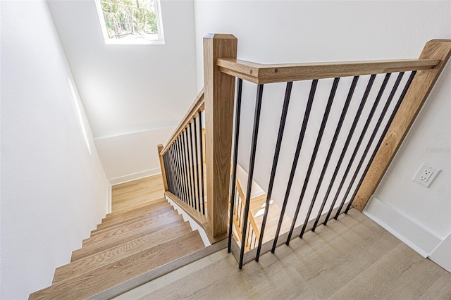 stairs with baseboards and wood finished floors