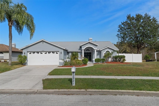 single story home featuring a garage and a front yard