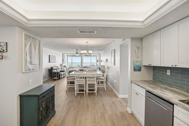 kitchen featuring dishwasher, light hardwood / wood-style flooring, a chandelier, decorative backsplash, and white cabinets