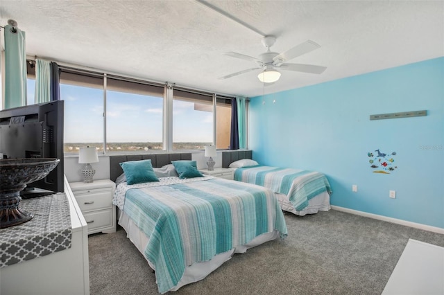 carpeted bedroom with a textured ceiling and ceiling fan