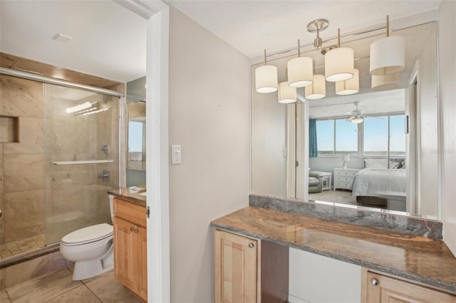 bathroom featuring tile patterned flooring, vanity, an enclosed shower, and ceiling fan