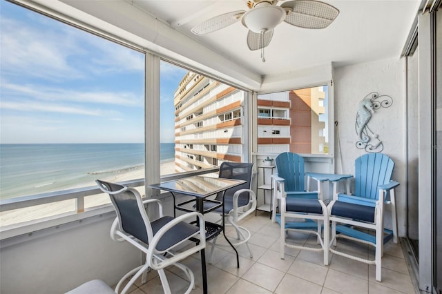 interior space featuring a beach view, a water view, and ceiling fan