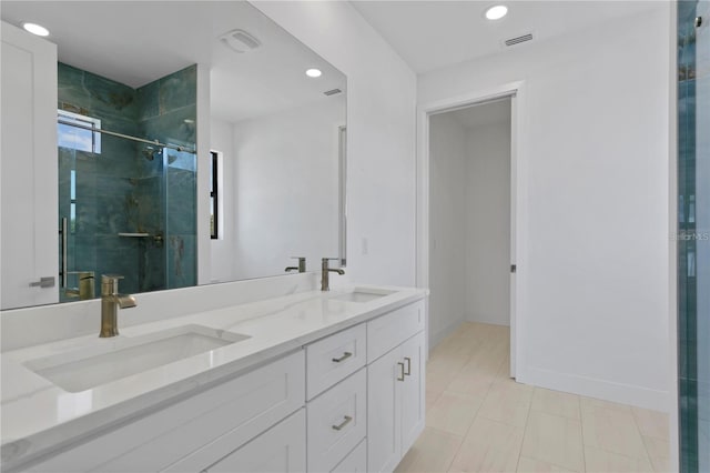 bathroom featuring vanity and a shower with shower door