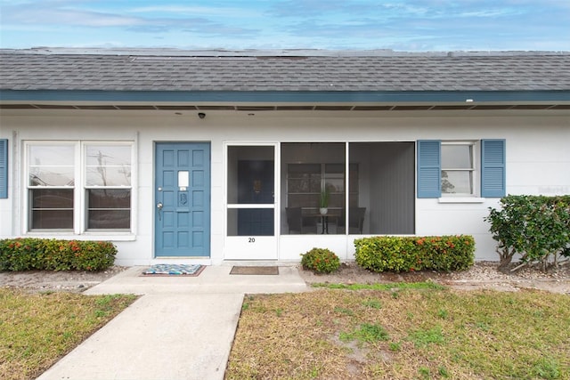 doorway to property with a yard