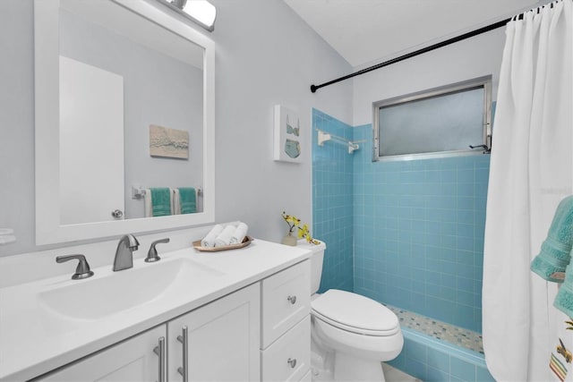 bathroom with toilet, vanity, and a shower with shower curtain