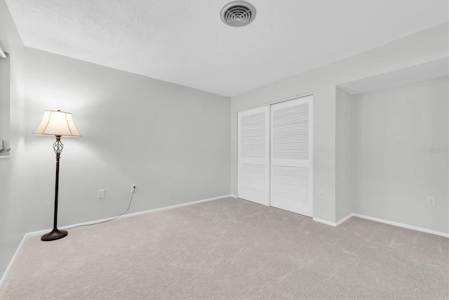 unfurnished bedroom featuring a closet and carpet floors