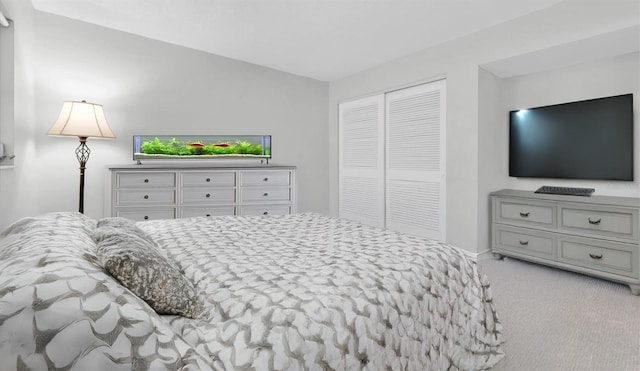 bedroom featuring light colored carpet and a closet