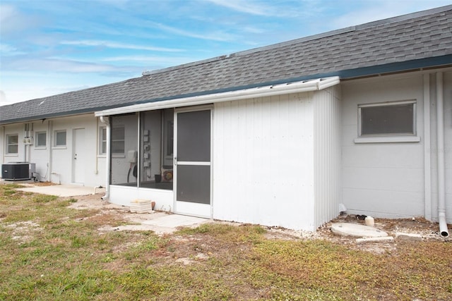 4444 Swift Rd Unit 20, Sarasota, FL 34231 - rear view of property with a shingled roof, central air condition unit, and a sunroom