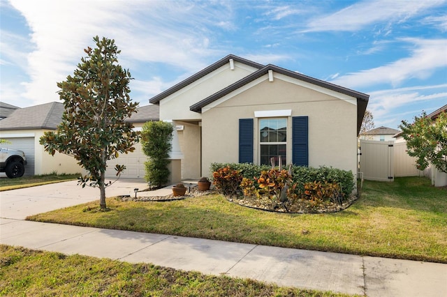 view of front of house with a front yard and a garage