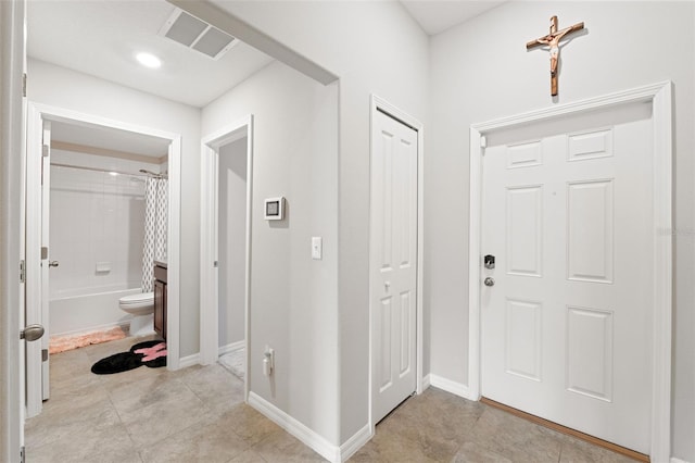 entryway with light tile patterned floors