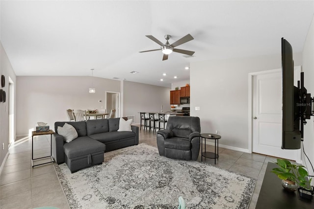 living room with ceiling fan, light tile patterned floors, and lofted ceiling