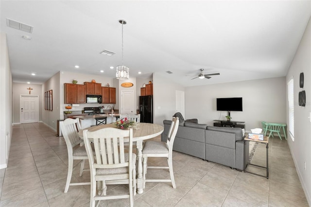 dining area featuring ceiling fan, light tile patterned floors, and sink