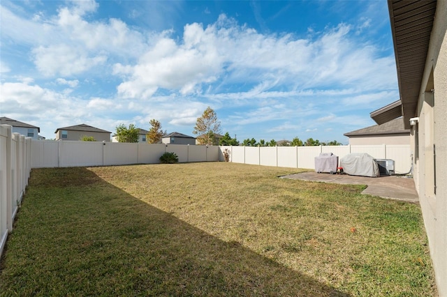 view of yard featuring a patio area and central AC