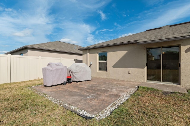 back of house featuring a patio area and a yard