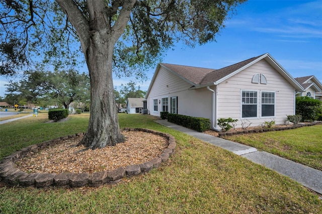 view of side of home featuring a lawn