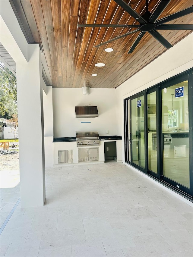 view of patio with ceiling fan, exterior kitchen, and area for grilling