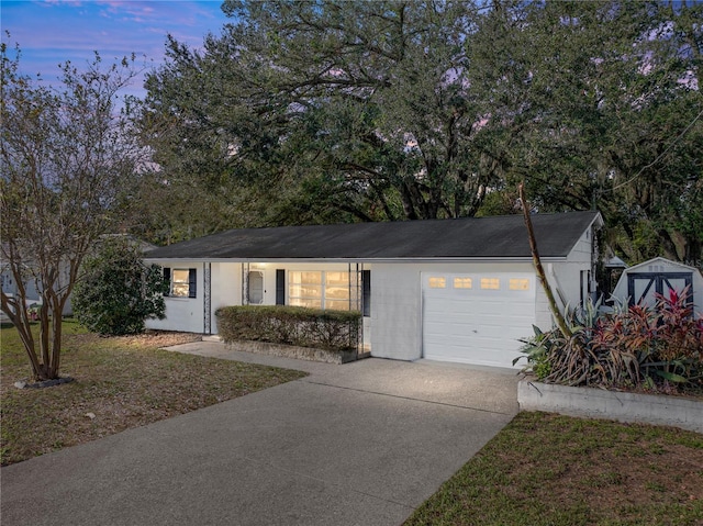 view of front of house featuring a lawn and a garage