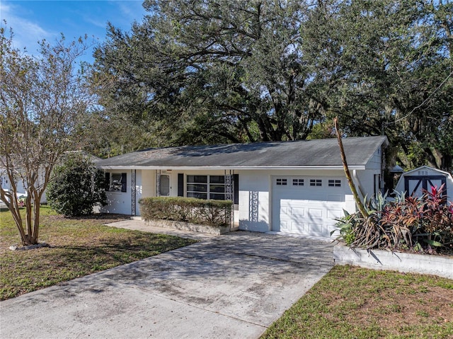 ranch-style house featuring a garage and a front yard