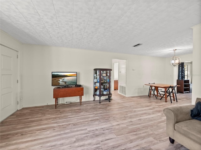 living area featuring a chandelier and light wood-type flooring