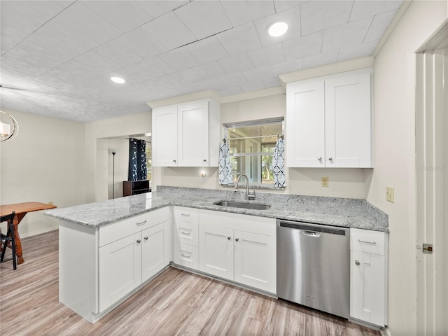 kitchen featuring dishwasher, white cabinets, light hardwood / wood-style flooring, and sink