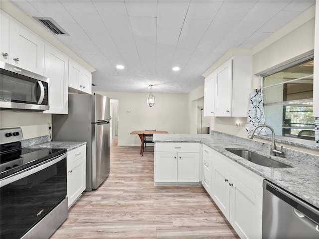 kitchen with white cabinets, sink, and stainless steel appliances