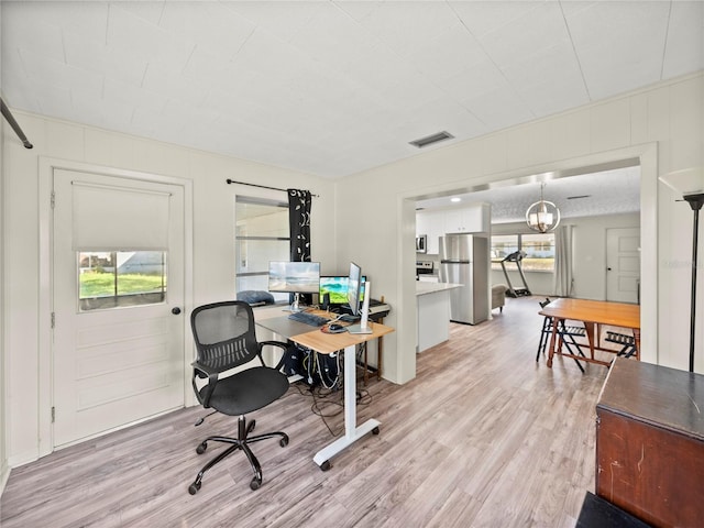 office area featuring light wood-type flooring and a notable chandelier