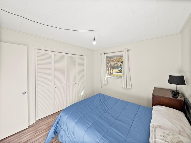 bedroom featuring hardwood / wood-style floors and a closet