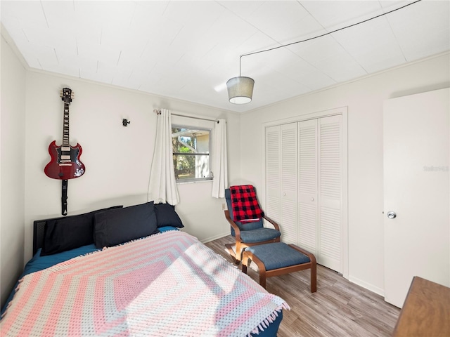 bedroom with light wood-type flooring and a closet