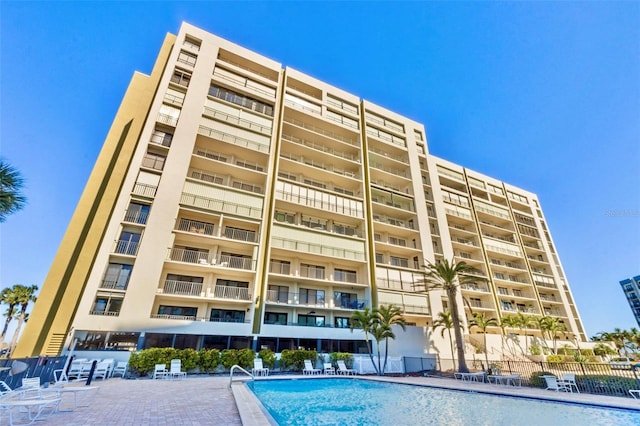 view of building exterior featuring a community pool