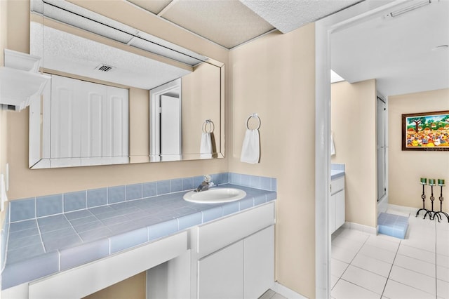 bathroom featuring tile patterned flooring and vanity