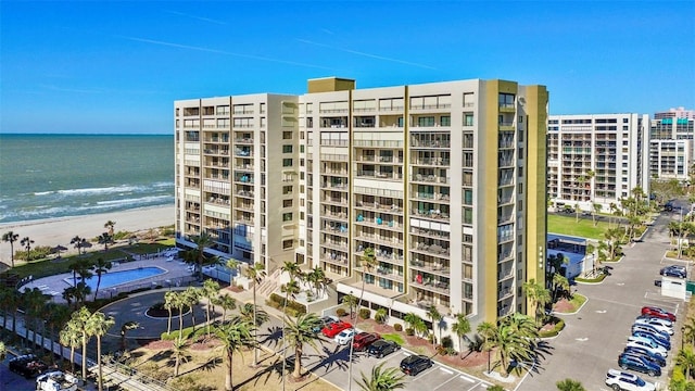 view of property with a water view and a view of the beach