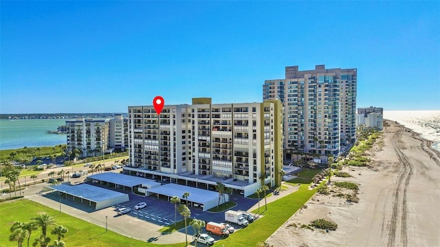 birds eye view of property with a view of the beach and a water view