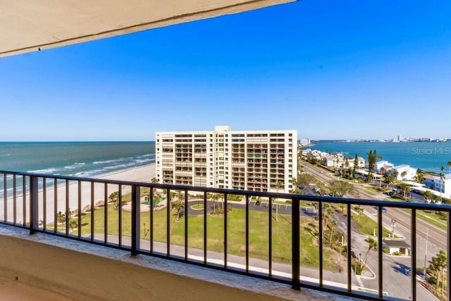 balcony featuring a water view and a view of the beach