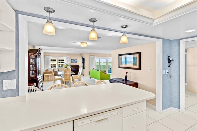 kitchen with white cabinetry, white dishwasher, hanging light fixtures, and light tile patterned floors