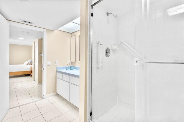 bathroom featuring vanity, tile patterned floors, and a shower with shower door