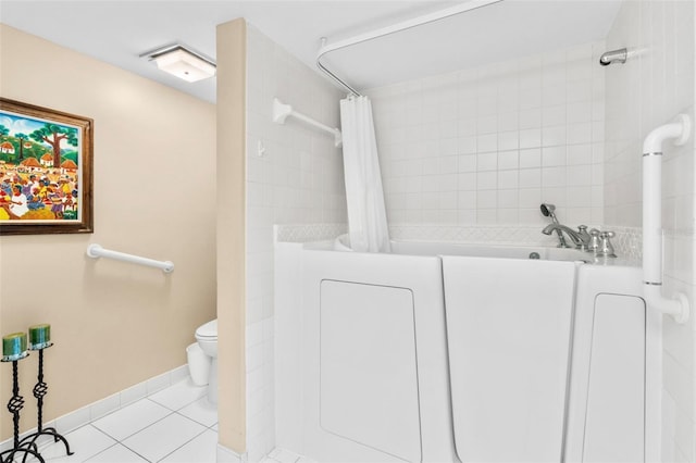 bathroom featuring toilet, shower with separate bathtub, tile patterned floors, and washer / dryer