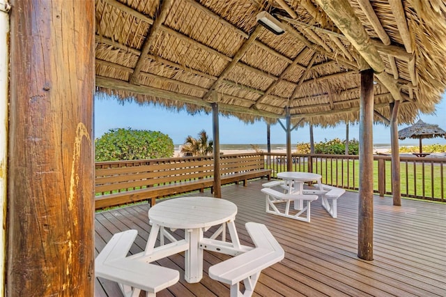 wooden terrace with a gazebo and a water view