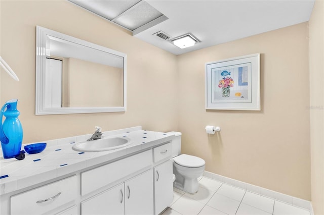 bathroom with tile patterned floors, vanity, and toilet