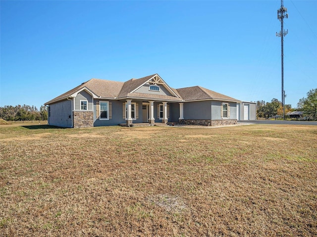 view of front of property featuring a front yard and a garage