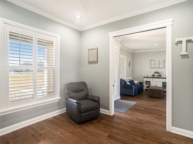 living area with ceiling fan, dark hardwood / wood-style flooring, and crown molding