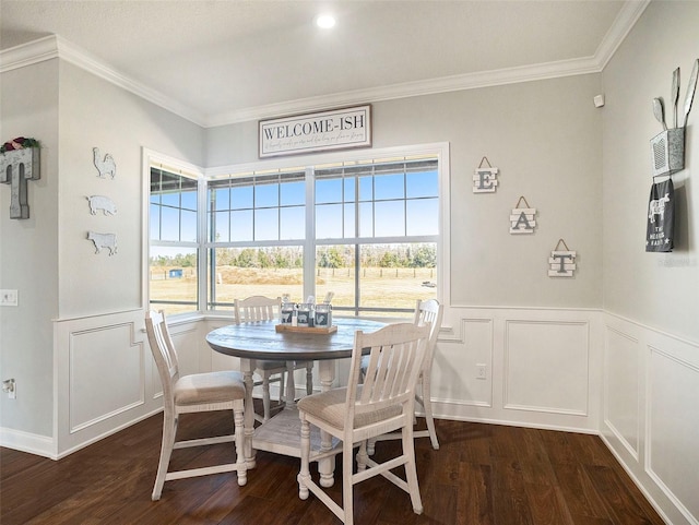 dining space with dark hardwood / wood-style floors, ornamental molding, and a wealth of natural light