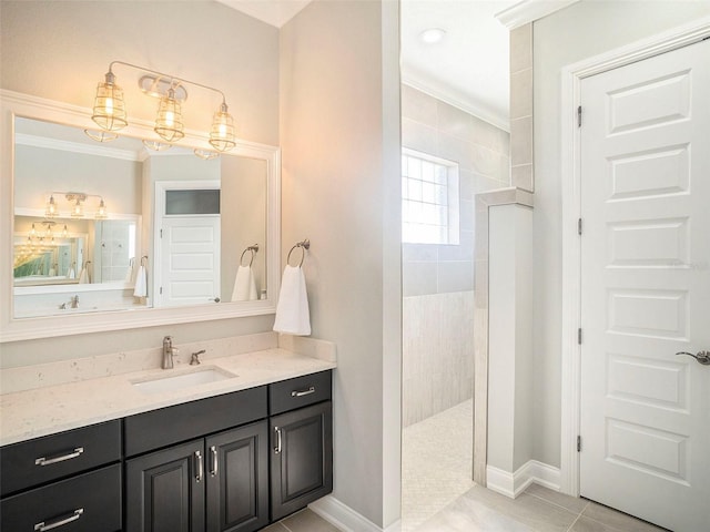 bathroom featuring a tile shower, vanity, tile patterned floors, and crown molding