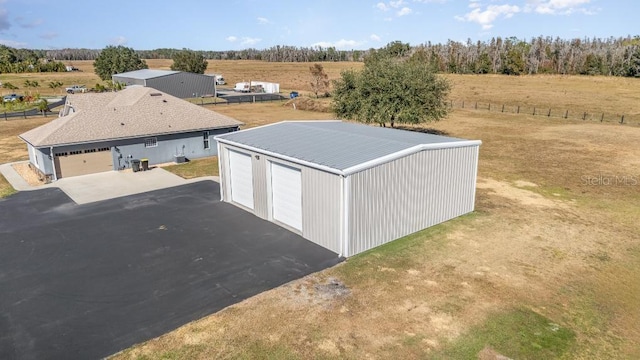 view of outdoor structure with a rural view and a garage