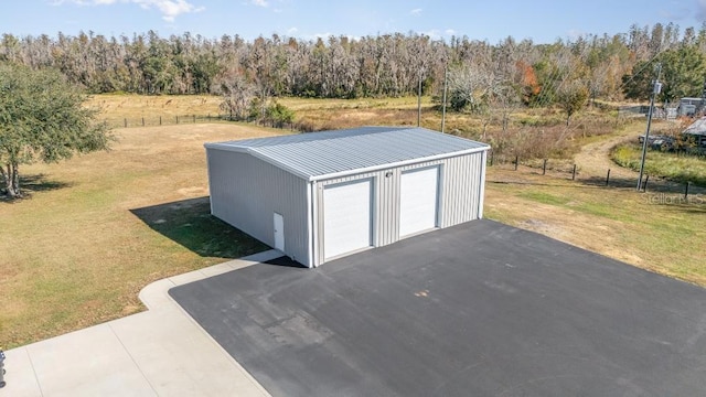 view of outbuilding with a lawn and a garage