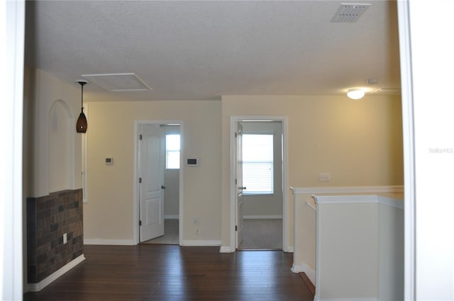 interior space with dark hardwood / wood-style floors and a textured ceiling