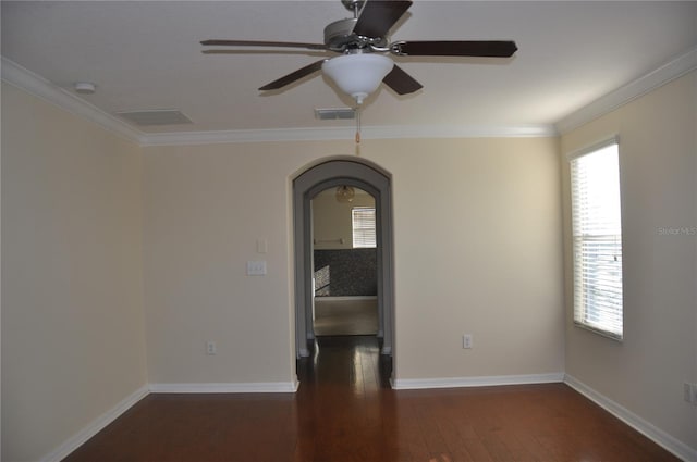 spare room with dark hardwood / wood-style floors, ceiling fan, and crown molding